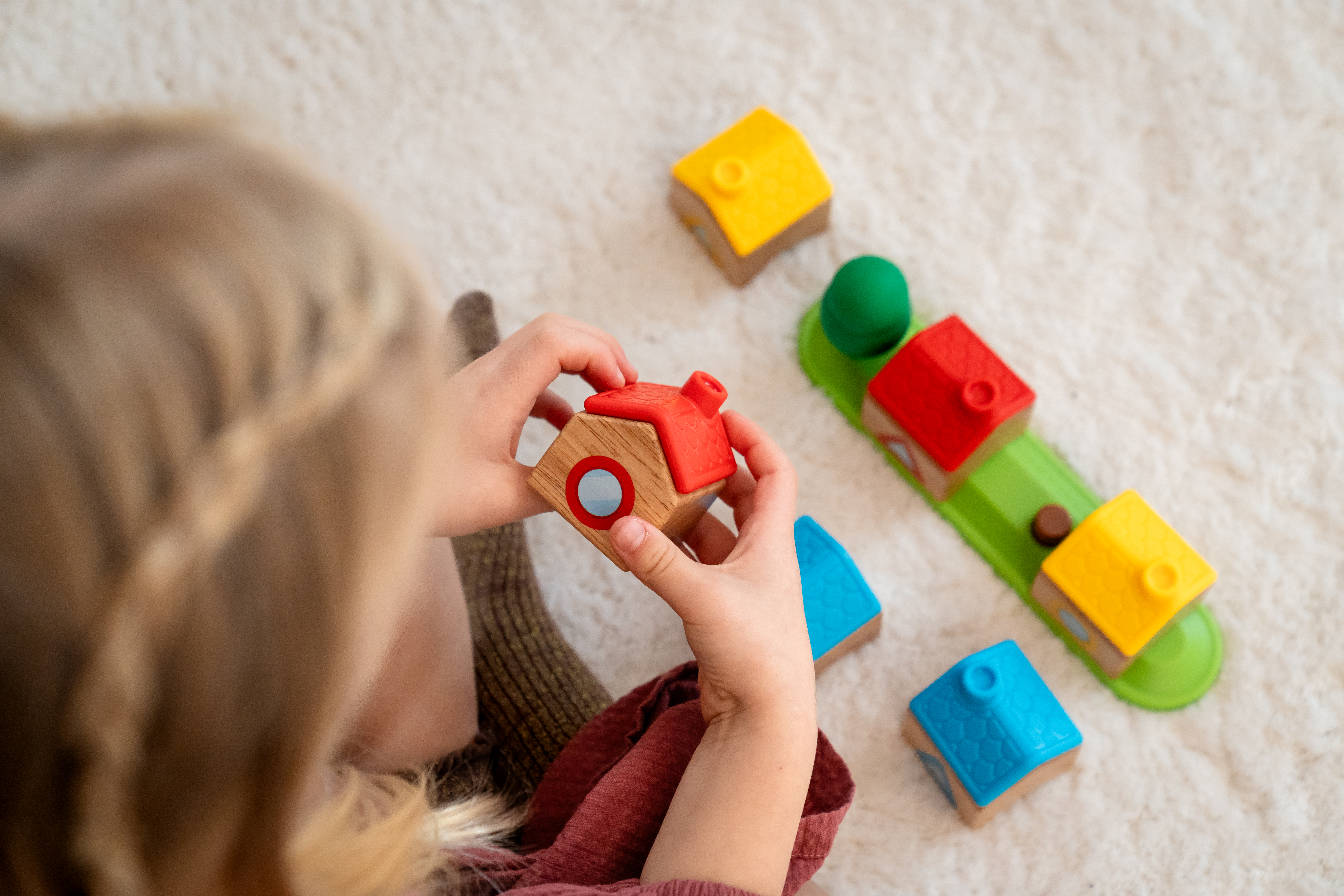 Example photo - child playing with wooden toys